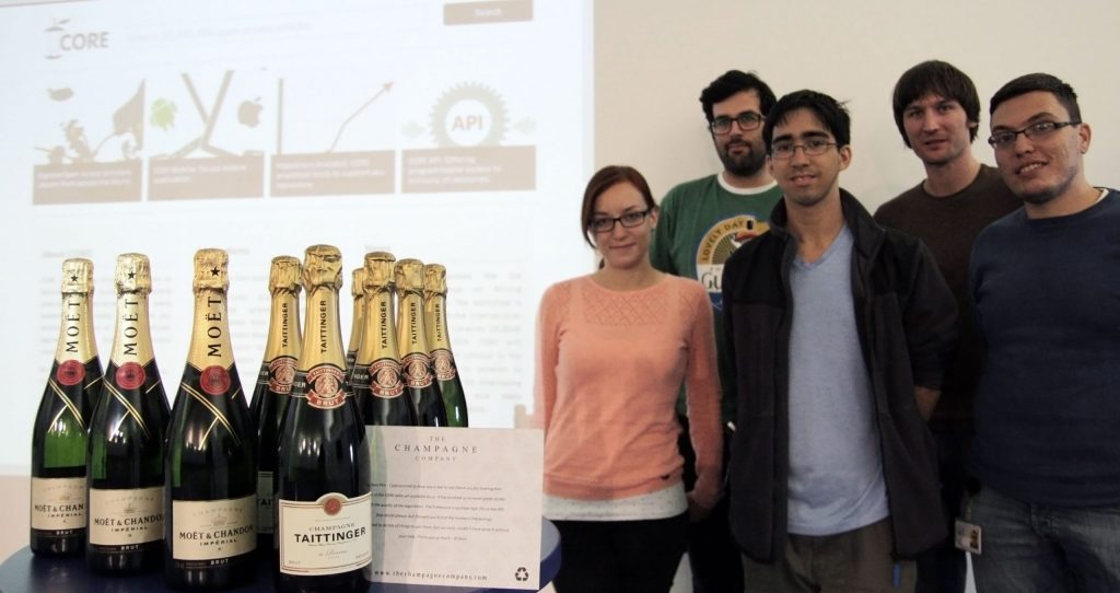 KMi Receives 12 Bottles of Quality Champagne as an Expression of Thanks for Our Research