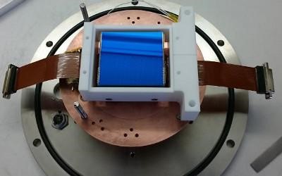 A blue and white device rests on a metal plate, showcasing its sleek design and contrasting colors.