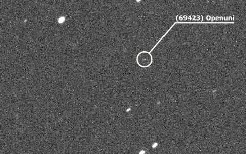 Black and white astronomical image showing the minor planet (69423) Openuni identified by a circle and label against a background of distant stars.